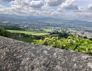 landscape of rolling green fields and town in Ireland