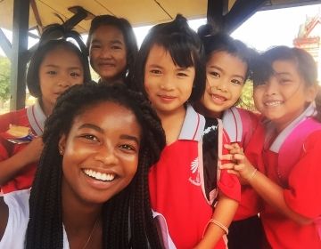 Teacher with group of kids in Thailand